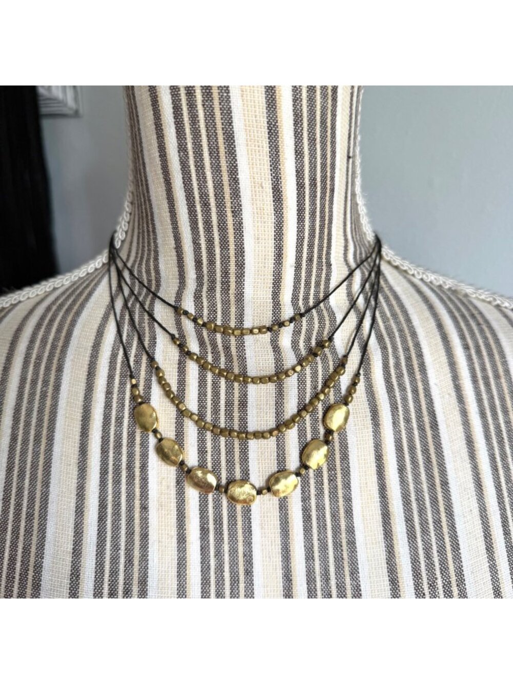 Four Strand Necklace with Gold Tone Beads and Black Leather Cords